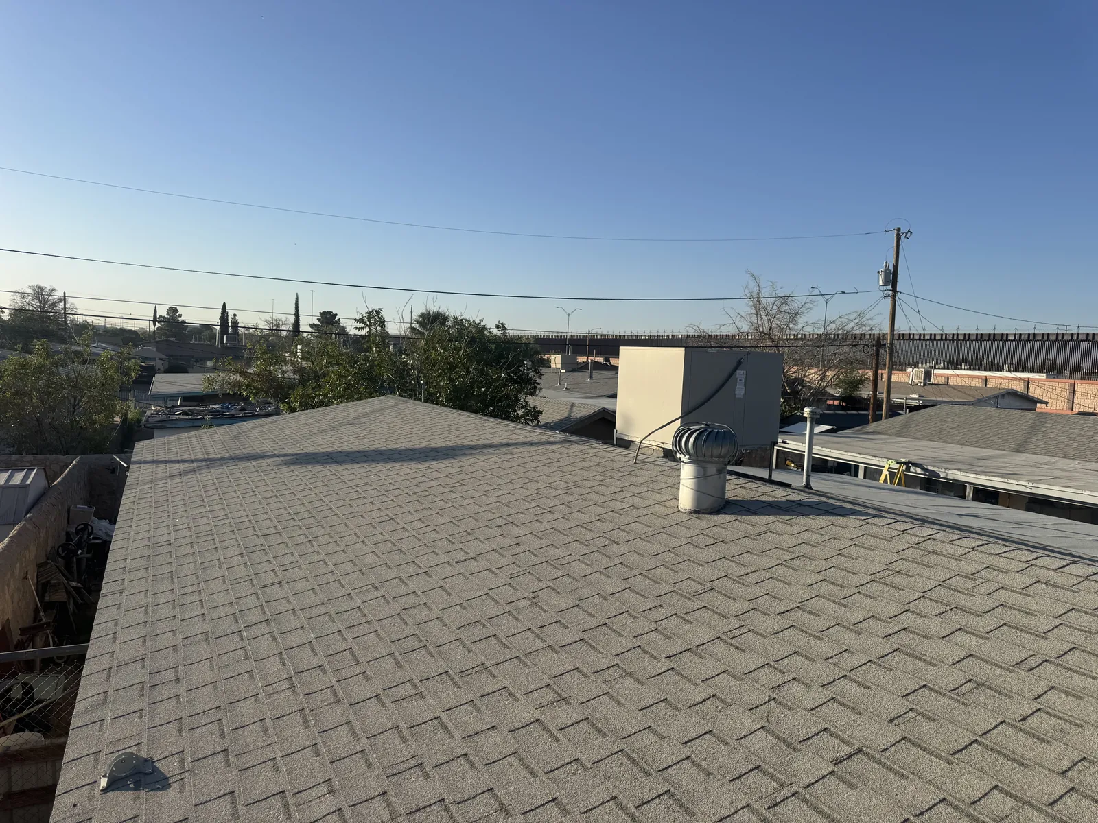 The old shingle roof with its turbine vent and swamp cooler, before work started
