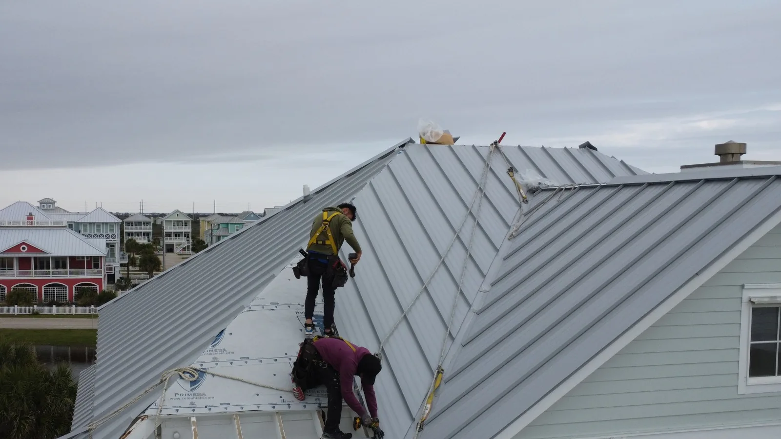 Manifest crew installing standing seam panels